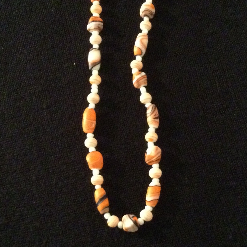 Women’s glass bead necklace in white, orange & black.